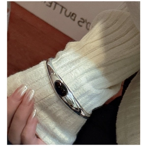 Detailed view of an S925 silver cuff bracelet with a large oval black agate gemstone