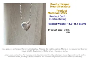 Detail of S925 sterling silver heart necklace with faceted pendant and ball chain texture