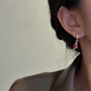 S925 sterling silver drop earrings with red layered beads on a model side view