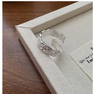Macro detail of S925 sterling silver ring featuring unique crumpled texture and open design