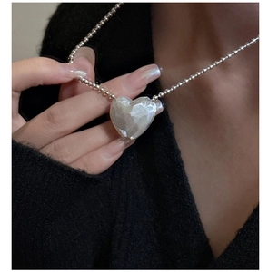 Close-up of S925 sterling silver heart pendant with textured lava finish on ball chain