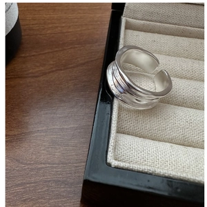Macro detail of silver ring featuring irregular hammered textures in a jewelry box