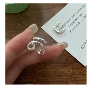 Detail of minimalist double-layered S925 sterling silver ear cuff shown on fingers