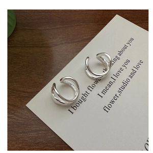 Detailed view of minimalist S925 sterling silver double-layer crisscross ear cuff on a card