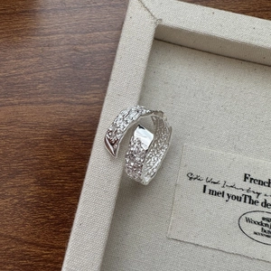 Minimalist S925 sterling silver open ring with unique lava texture on a jewelry tray