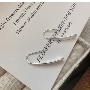Close-up of S925 sterling silver ear wire earrings with a sleek brushed matte finish