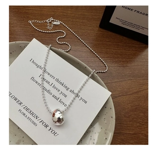 Macro detail of S925 sterling silver hammered teardrop pendant and adjustable bead chain
