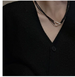 Detail of s925 silver Y-shaped clasp on a double-layer black beaded minimalist necklace