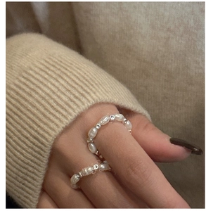 Close-up of S925 silver square beads and white baroque pearls on a beaded ring