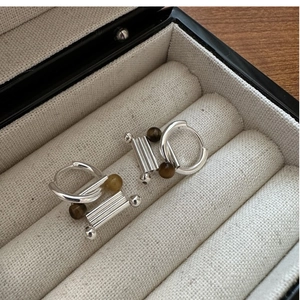 Detail of S925 silver hoop earrings with rectangular pendants and tiger eye stone beads