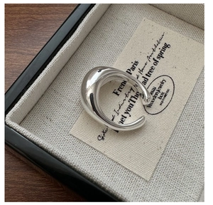 Macro shot of minimalist thick S925 sterling silver open ring with polished mirror finish