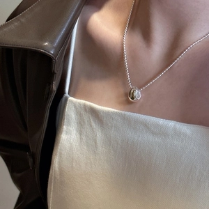 Minimalist S925 sterling silver bean pendant necklace with polished mirror finish on model