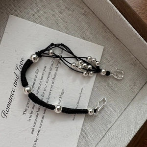 Handcrafted minimalist black braided rope bracelet with polished silver metal beads