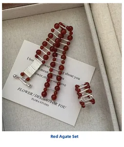 Red agate bead jewelry set featuring bracelet and ring on a vintage display card