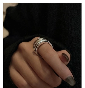 Close-up of a wide polished S925 sterling silver minimalist ring worn on a hand