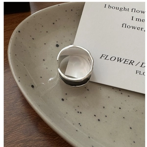 Detail of S925 sterling silver ring with black enamel inlay on ceramic tray