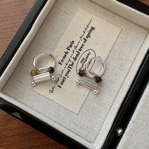 S925 sterling silver earrings with tiger eye stone beads on a jewelry display box