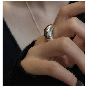 Close-up of minimalist S925 sterling silver ring with a polished dome finish on finger