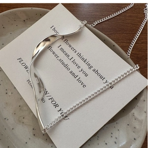 Detail of S925 sterling silver necklace showing lava texture and hallmark on white card