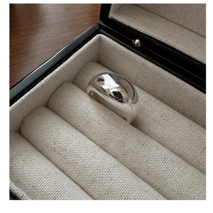 Close-up of a wide polished S925 silver ring presented in a luxury jewelry gift box
