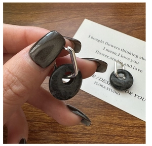 Detail view of S925 sterling silver earrings with dark grey natural stone and geometric hoop