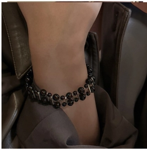 Close-up of double-strand black agate bead bracelet with silver vertical column accents