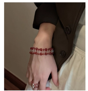 Detail of red agate bead bracelet and ring set with double-row parallel silver bars