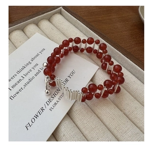 Close-up of S925 silver bracelet featuring double-row red agate beads and T-bar clasp