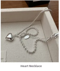 Macro detail of S925 sterling silver heart necklace with unique spliced chain textures