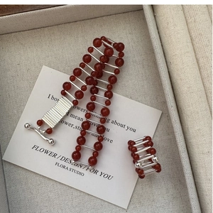 Macro shot of S925 silver red agate bead jewelry set with intricate ladder link design