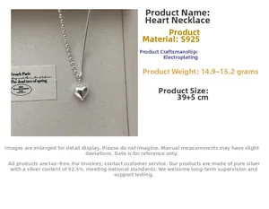 Macro shot of S925 silver heart necklace showing asymmetric bead and snake chain details