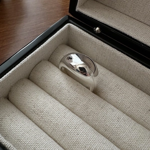 S925 sterling silver minimalist dome ring with high polish finish in a jewelry box