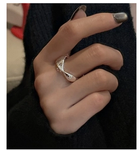 Detailed view of S925 sterling silver ring with wave texture on female hand
