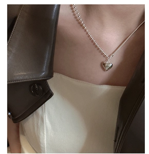 Detail of S925 sterling silver heart necklace with asymmetric bead and snake chain links