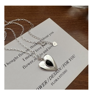 Detail of S925 sterling silver heart pendant with black onyx and engraved S925 hallmark