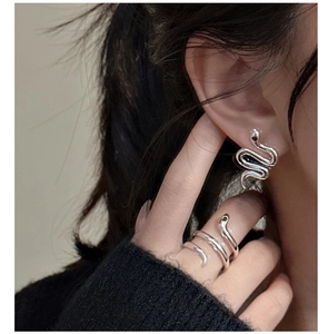 Detailed shot of S925 sterling silver snake earring and matching open ring on a model