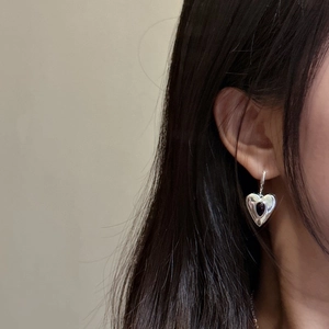 S925 sterling silver heart earrings with black onyx gemstone worn by a female model