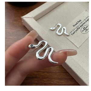 Detail of S925 sterling silver snake earrings featuring black zircon eyes and sleek curves