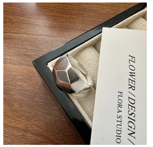 Macro shot of S925 sterling silver geometric faceted ring on a luxury jewelry box