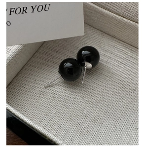 Close-up of polished black onyx round stud earrings with S925 sterling silver posts