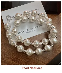 Macro shot of high-luster white pearls and silver metal beads with unique OT toggle clasp