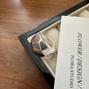 Minimalist S925 sterling silver geometric faceted ring with a matte finish on wood
