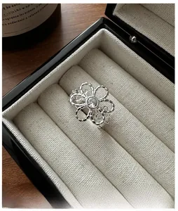Macro detail of S925 sterling silver flower ring with zircon in a black jewelry box