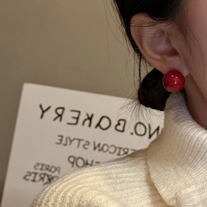 Minimalist S925 sterling silver red shell pearl stud earrings on a model ear