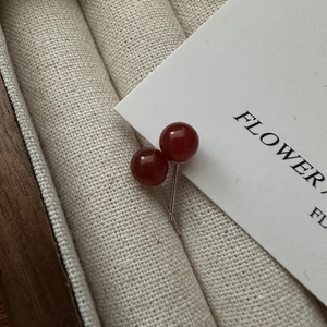 Elegant S925 sterling silver stud earrings with polished red agate beads in a gift box