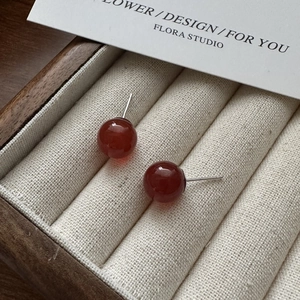 Minimalist S925 silver stud earrings with round red agate beads on a velvet jewelry box