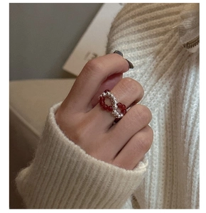 Detailed shot of S925 silver beaded ring with red carnelian beads on a hand