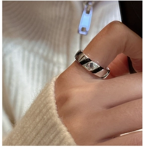 Close-up of S925 sterling silver wide ring with black enamel diagonal stripes on finger