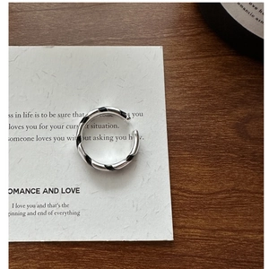 Macro detail of S925 sterling silver ring with black enamel diagonal stripes on card