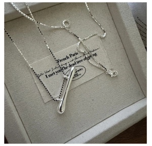 Macro shot of S925 sterling silver liquid teardrop pendant on a fine box chain